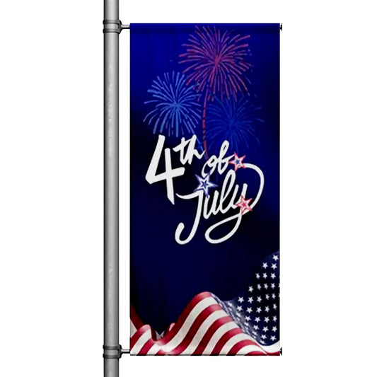 4th of July pole banner featuring patriotic fireworks and American flag design mounted on street pole