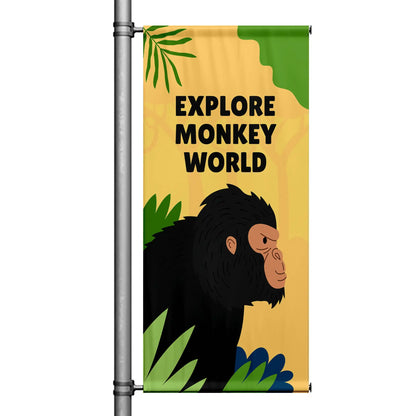Explore Monkey World yellow street pole banner featuring illustrated monkey and jungle foliage