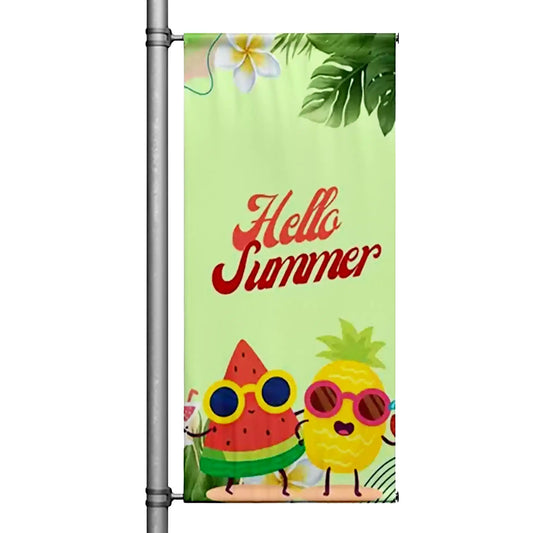 Hello Summer pole banner with smiling watermelon and pineapple illustration on green tropical background mounted on street pole