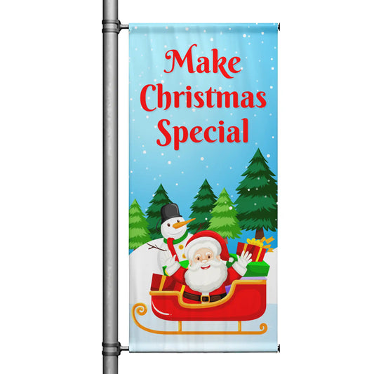 Make Christmas Special Christmas pole banner with blue snowy background, Santa in sleigh, snowman, evergreen trees, and cheerful holiday design