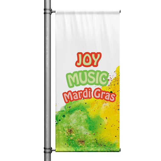 Mardi Gras pole banner featuring “Joy Music Mardi Gras” text with green and yellow paint splash design on white background