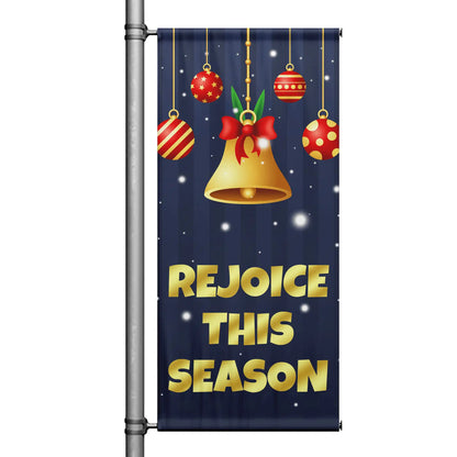 Rejoice This Season Christmas pole banner with navy background, gold lettering, hanging ornaments, and festive bell design