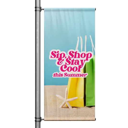 Sip Shop Stay Cool light blue street pole banner with summer shopping bags and beach accents