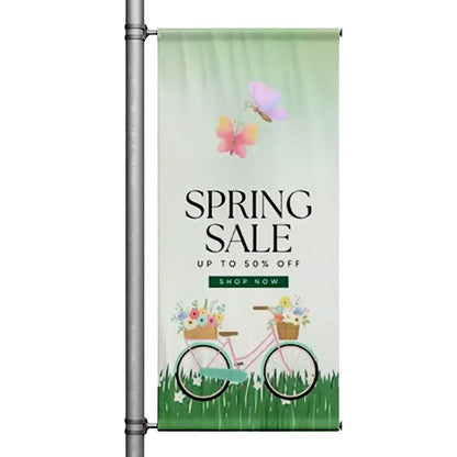 Spring Sale pole banner featuring floral bicycle illustration and pastel spring colors mounted on street pole