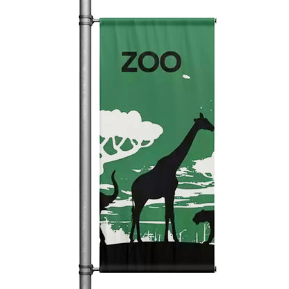 Zoo themed pole banner with giraffe silhouette and green nature background mounted on street pole