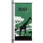 Zoo themed pole banner with giraffe silhouette and green nature background mounted on street pole