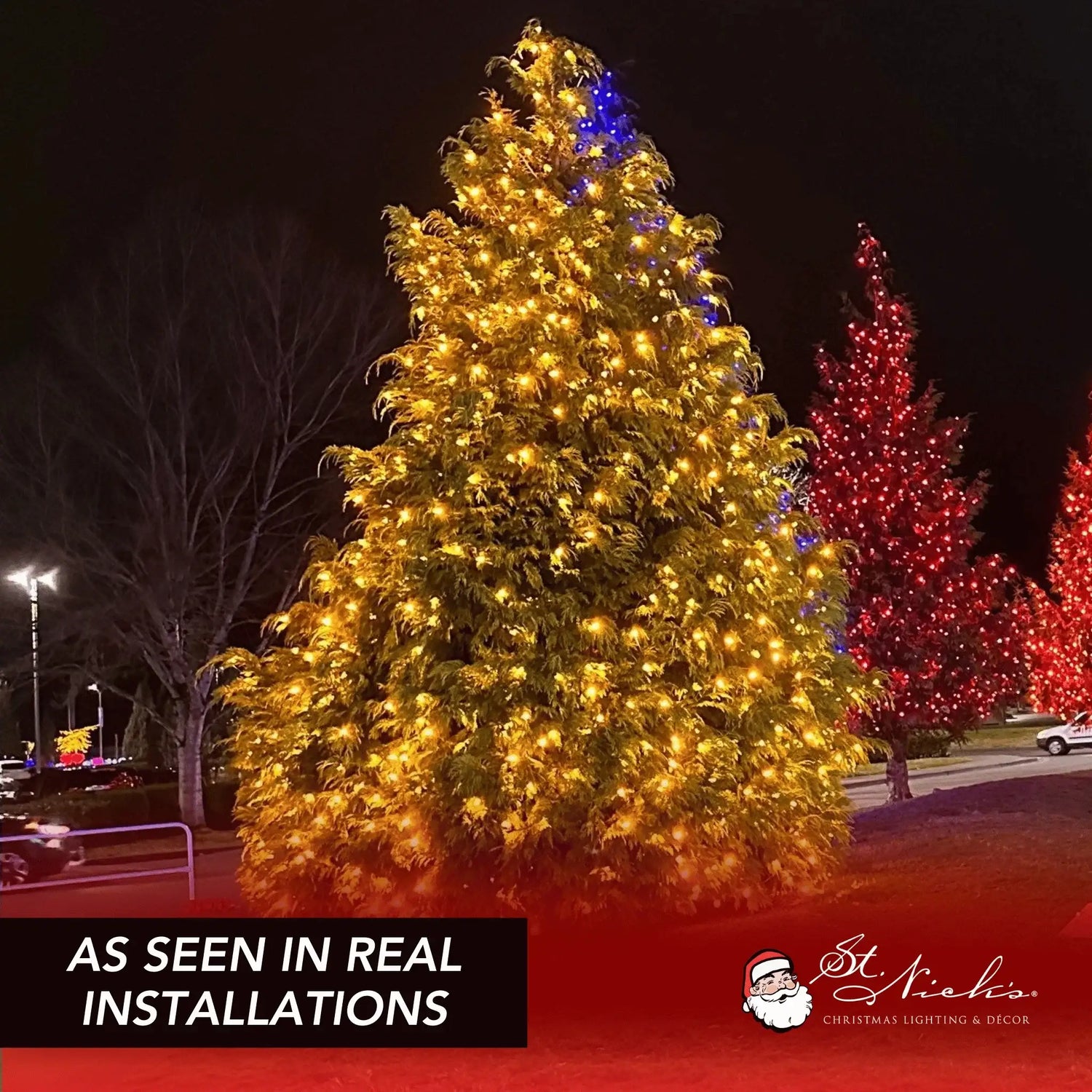 Orange LED mini lights installed throughout a large outdoor tree in a commercial lighting display