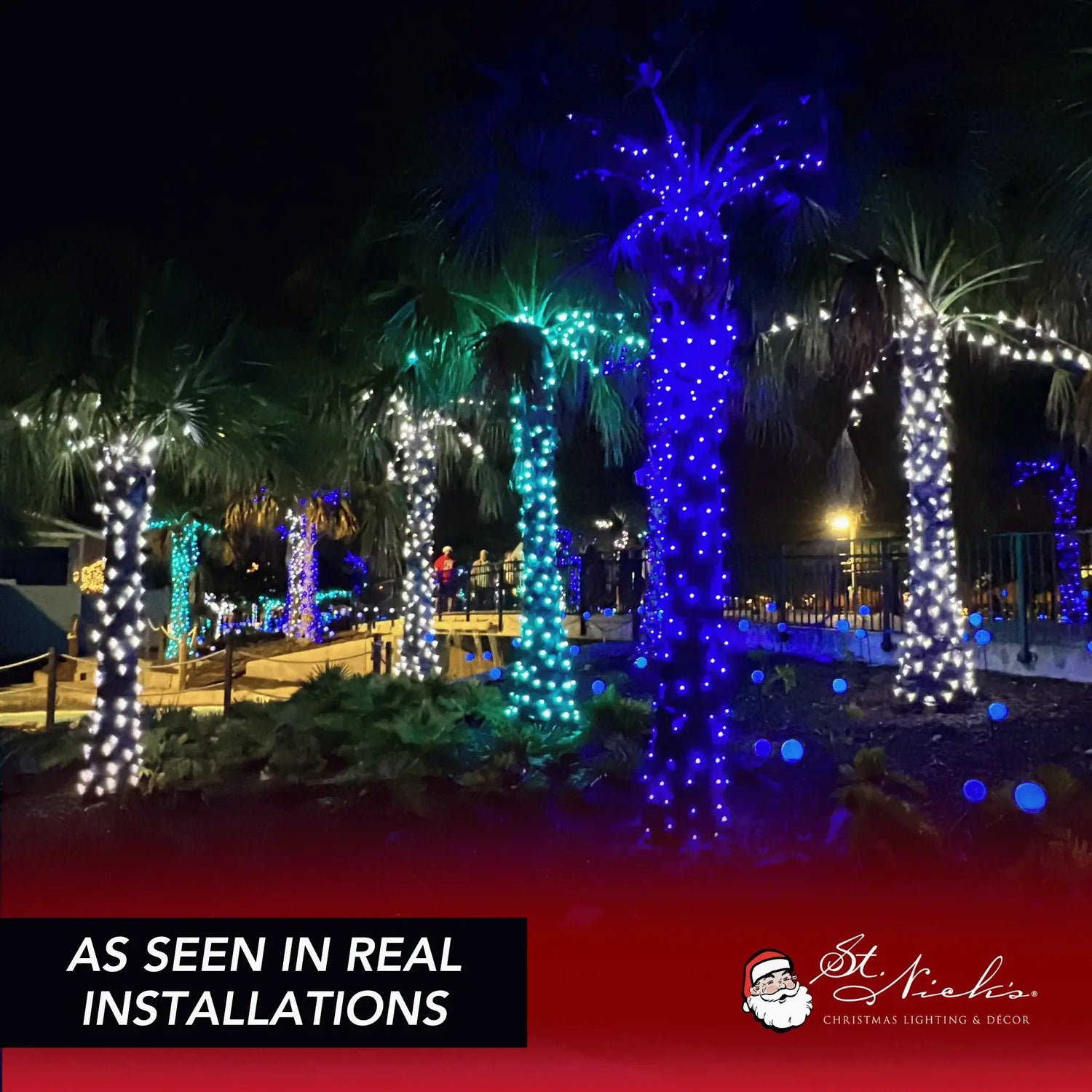 Blue 5mm LED mini lights wrapped around palm trees in a commercial outdoor holiday installation