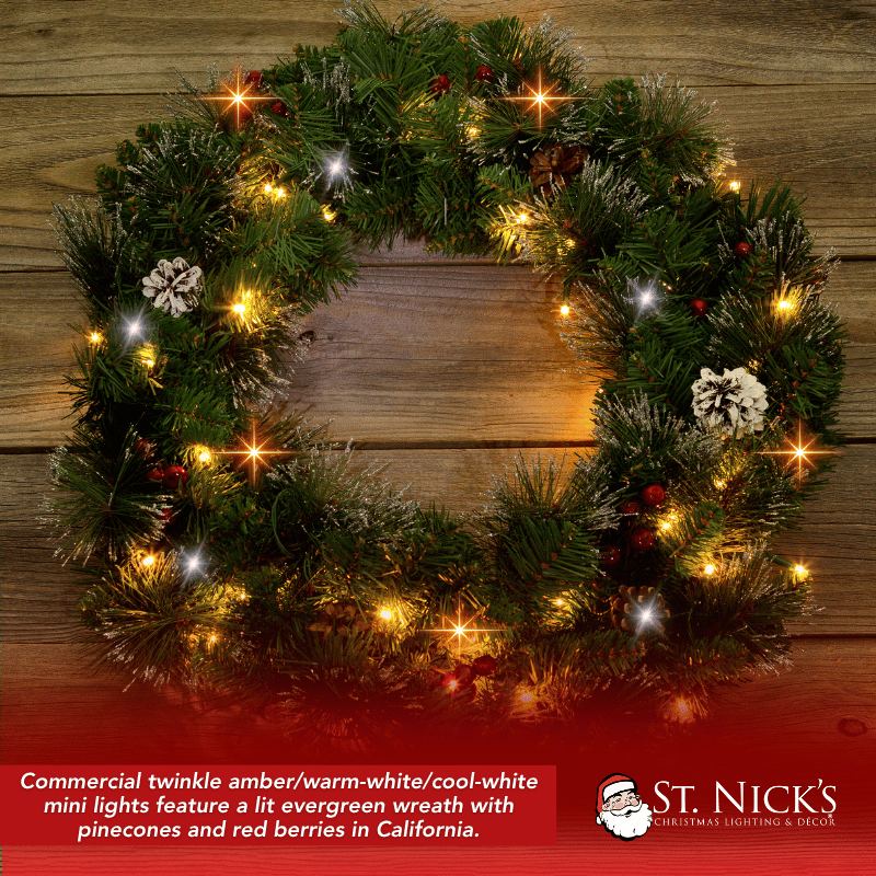 Evergreen Christmas wreath with pinecones and red berries illuminated by amber, warm white, and cool white twinkle lights.