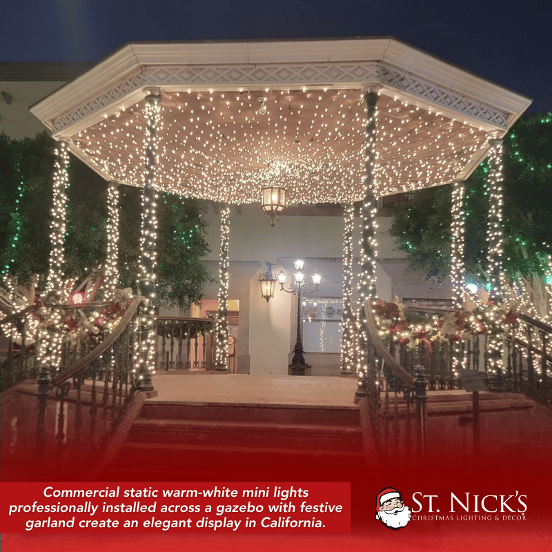 A gazebo in Lynwood, California, glows with dense warm white mini lights across its canopy, columns, and decorated railings.