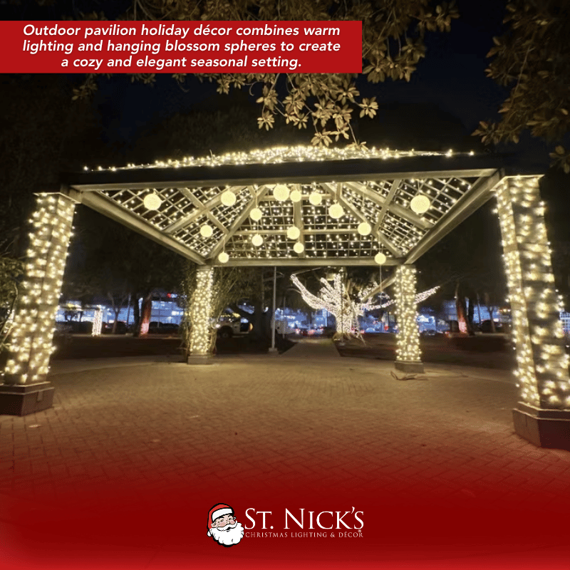 Outdoor pavilion wrapped in warm white mini lights with illuminated columns and hanging light spheres in Culver, California.