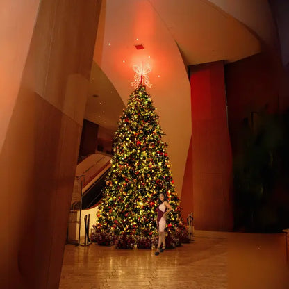 Decorated Christmas tree with lights in a large indoor space
