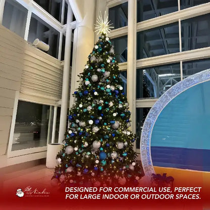 Decorated Christmas tree with teal blue silver and white ornaments in a large indoor space.