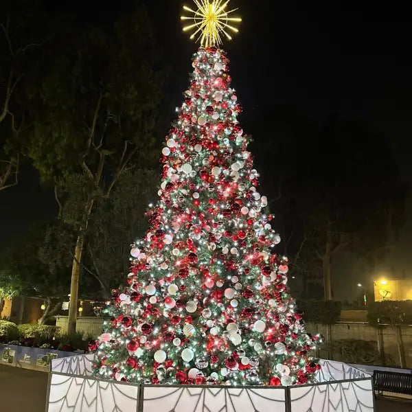 Decorated Christmas tree with red, white, and silver ornaments commercial outdoor