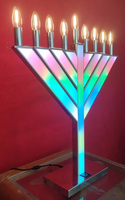 Multicolored Menorah with lit candles 