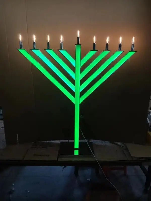 Menorah with green glow and lit candles 