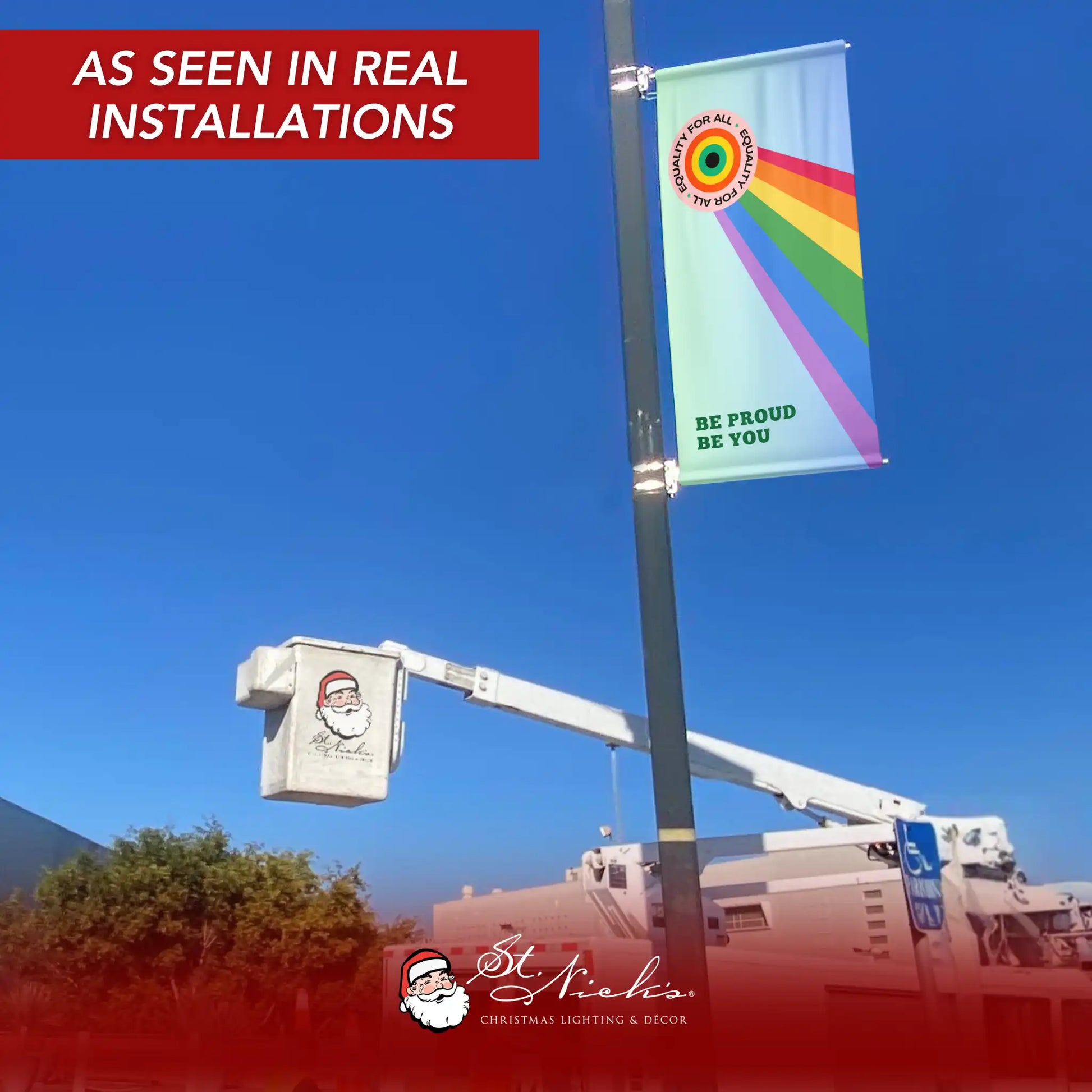 Be Proud Be You Pride Month pole banner displayed on a street pole in a real-world installation