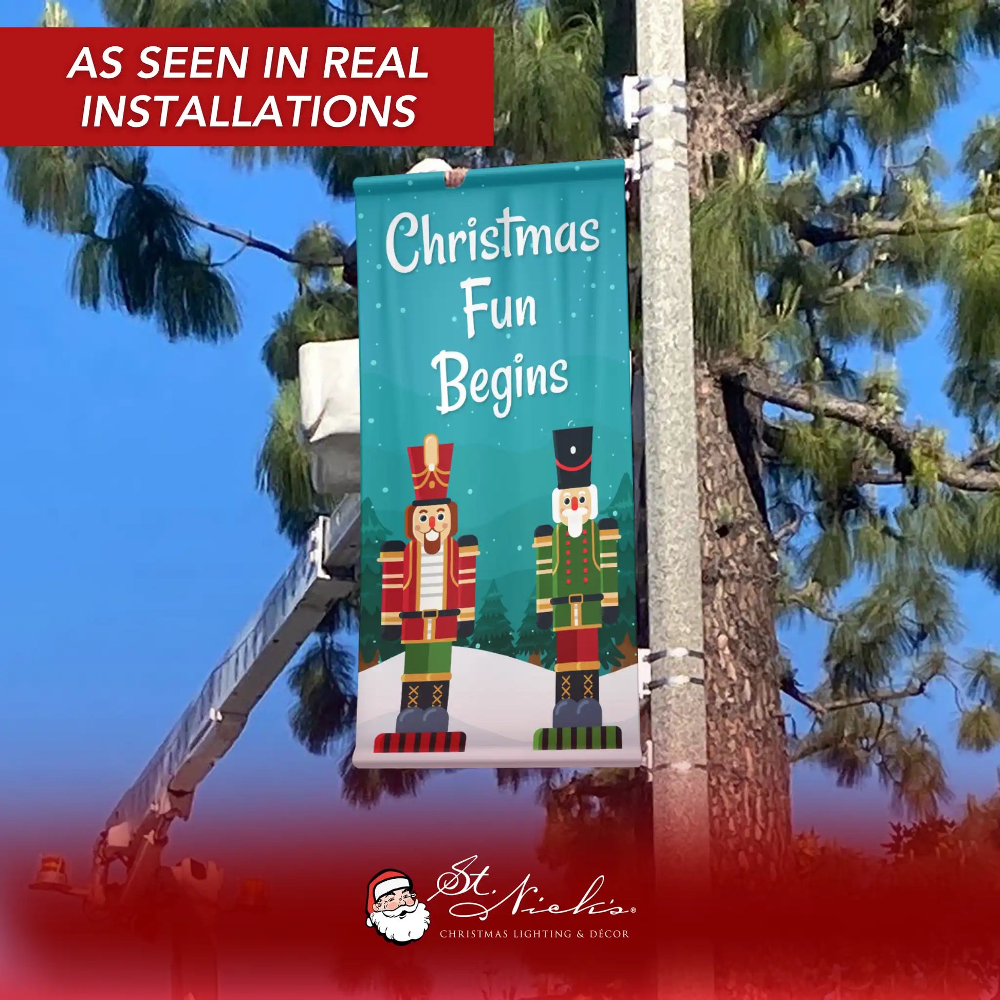 Christmas Fun Begins Christmas pole banner displayed on street pole in real installation