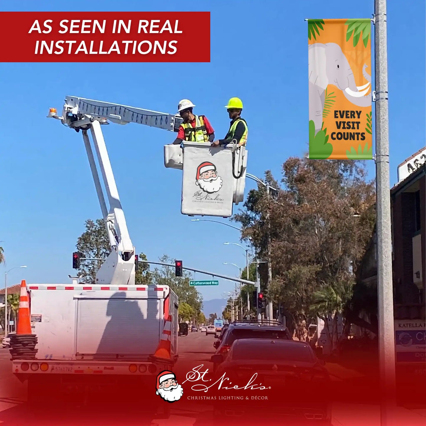 Every Visit Counts elephant pole banner installed on streetlight during professional setup