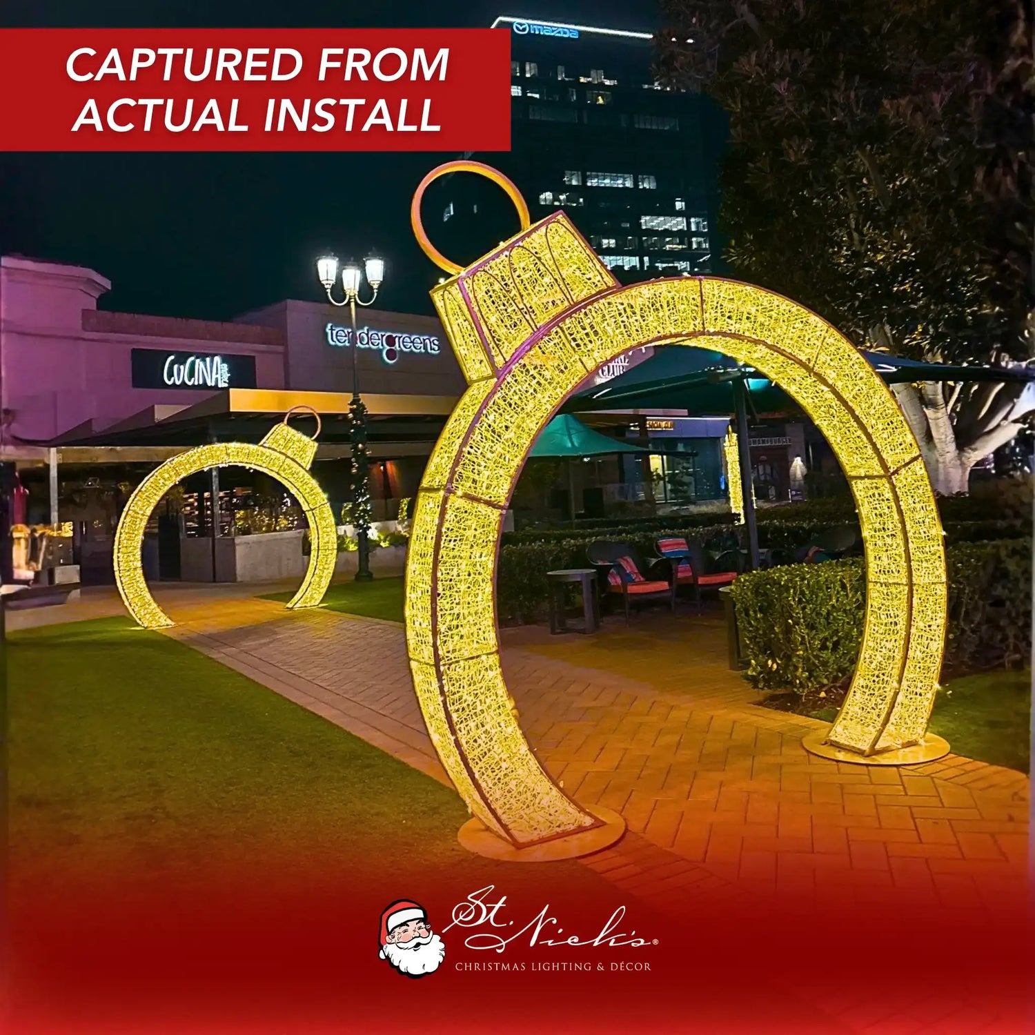 12ft gold walkthrough ornament arch at night with warm white LED lighting