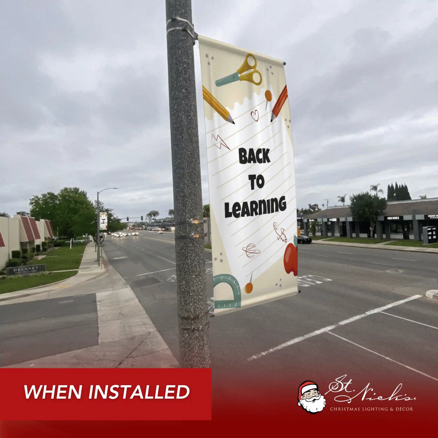 Back to Learning school pole banner installed along city street for back-to-school décor