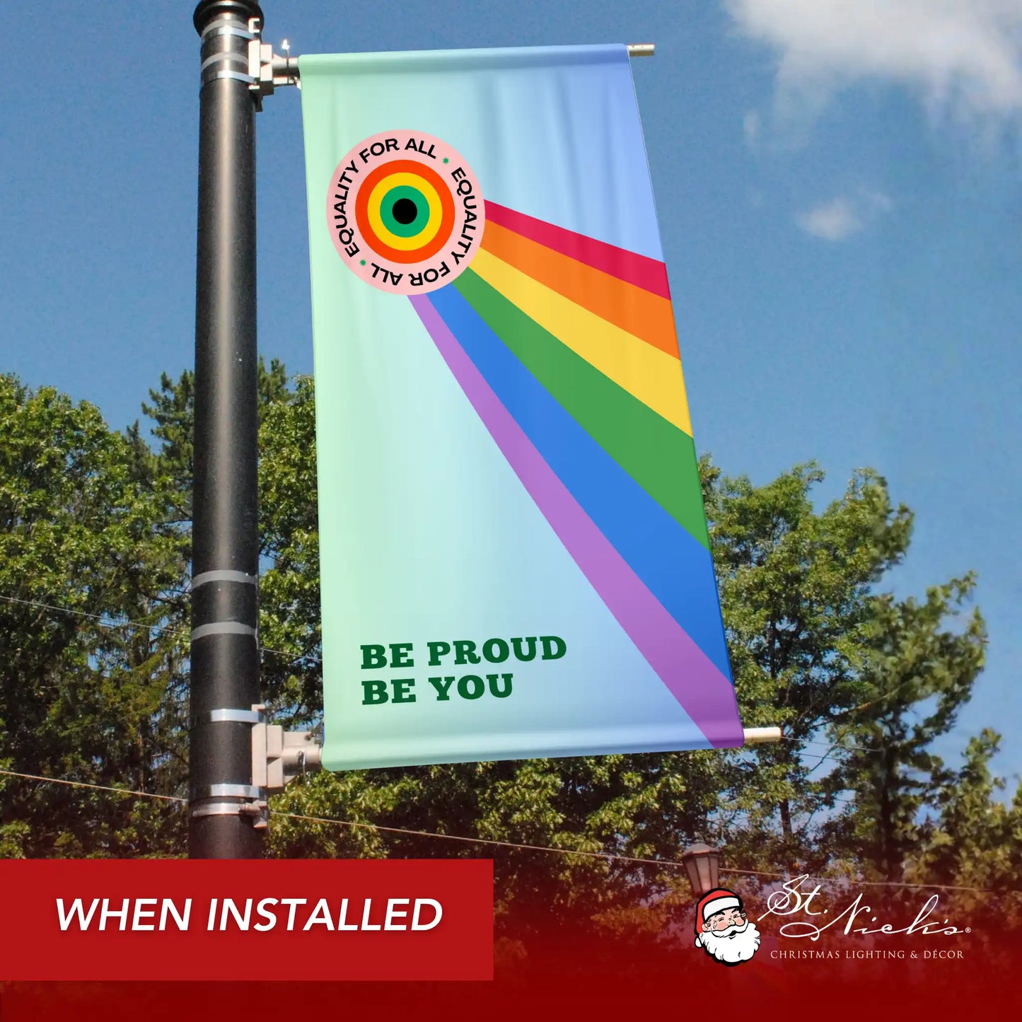 Be Proud Be You Pride Month pole banner shown installed outdoors on a city light pole