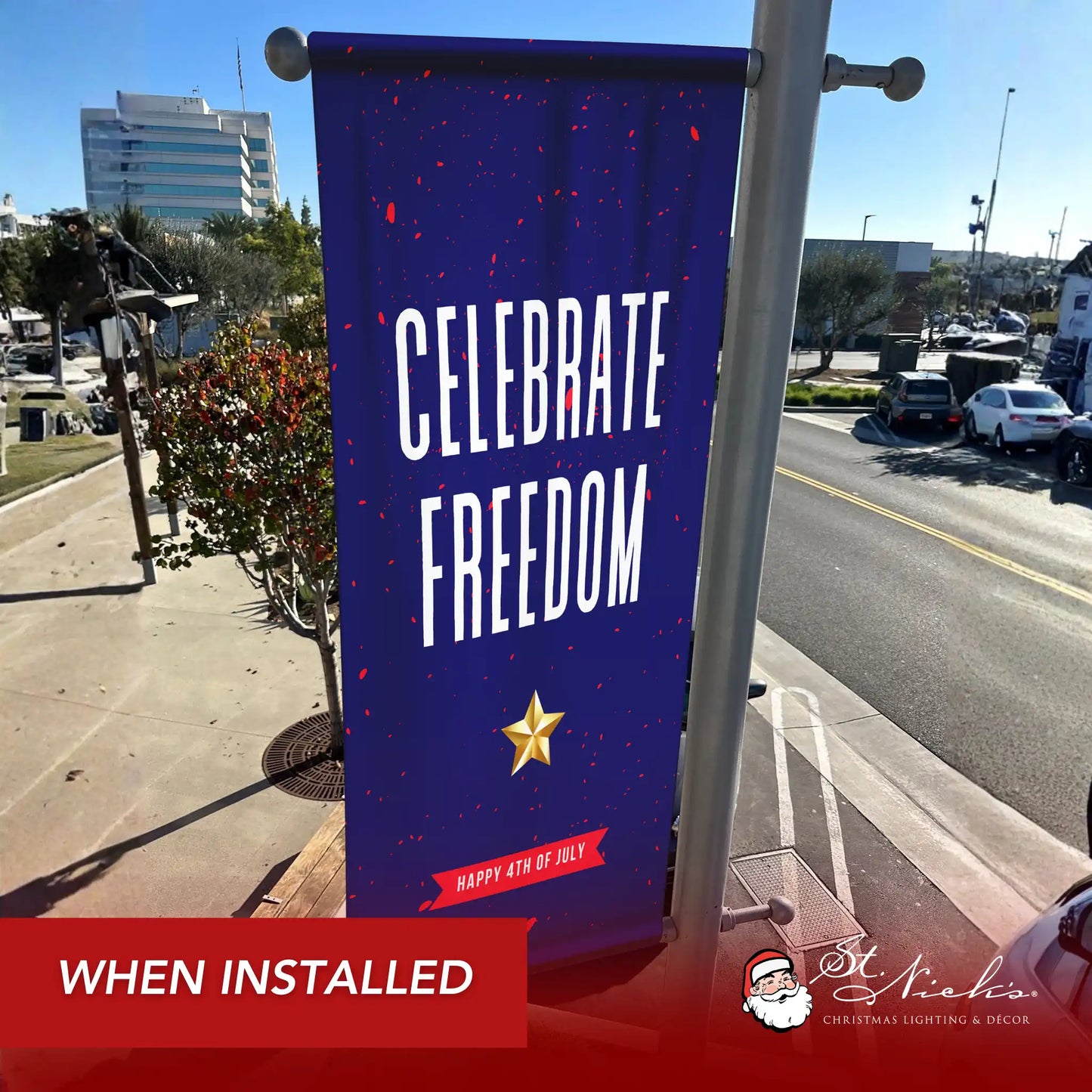 Celebrate Freedom 4th of July pole banner installed along city street for patriotic Independence Day décor