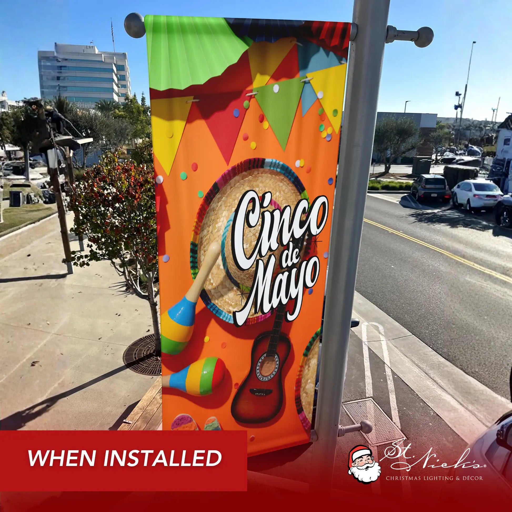 Cinco de Mayo pole banner with sombrero, maracas, and guitar design shown installed on city street pole