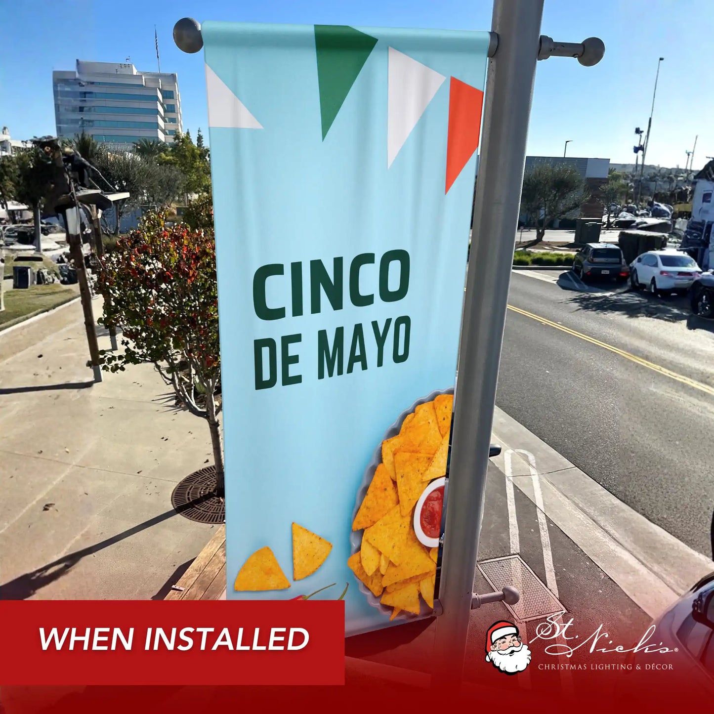 Cinco de Mayo pole banner with tortilla chips and peppers shown installed on city street pole