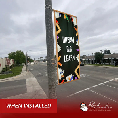 Dream Big Learn school pole banner installed along city street for back-to-school décor