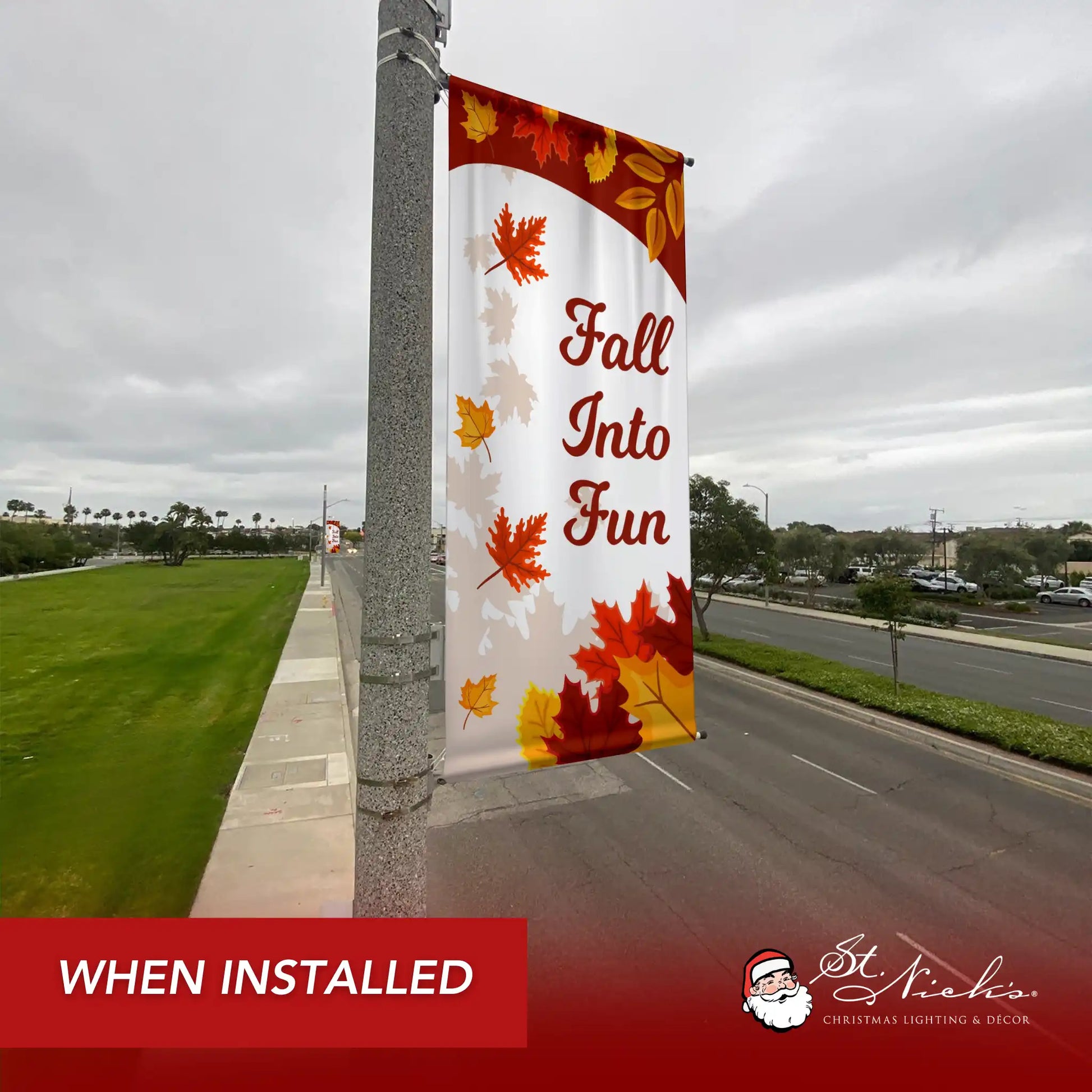 Fall Into Fun autumn pole banner installed along city street for seasonal autumn décor