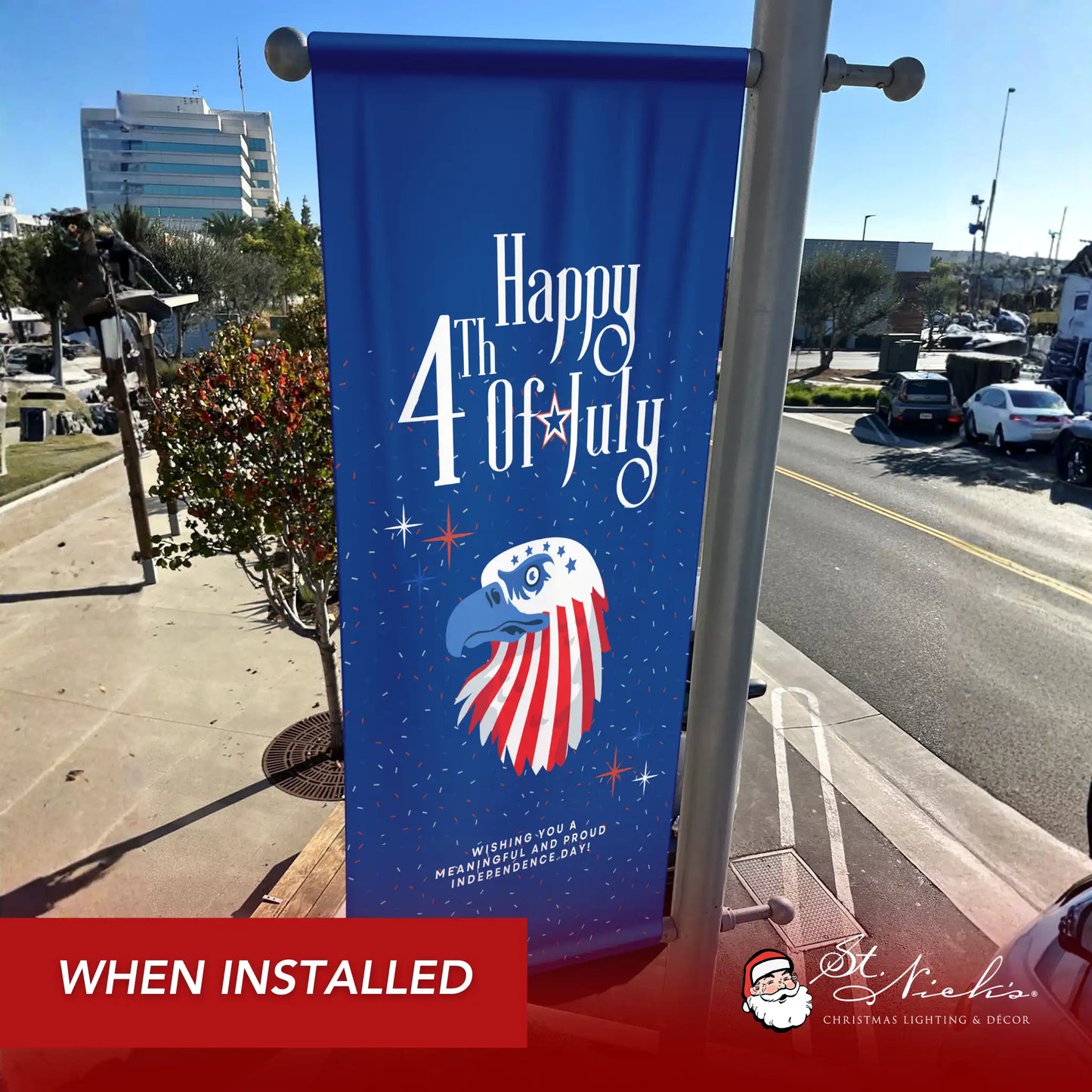 Happy 4th of July eagle pole banner installed along city street for patriotic Independence Day décor