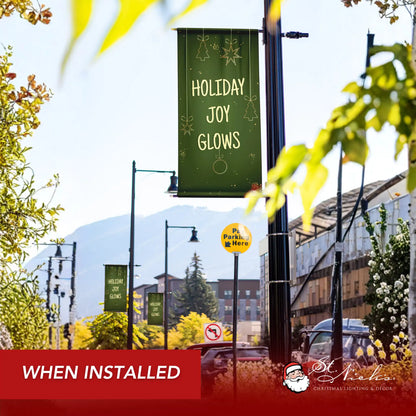 Holiday Joy Glows Christmas pole banner installed along city street for seasonal decoration