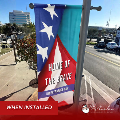 Home of the Brave Independence Day pole banner installed along city street for patriotic décor
