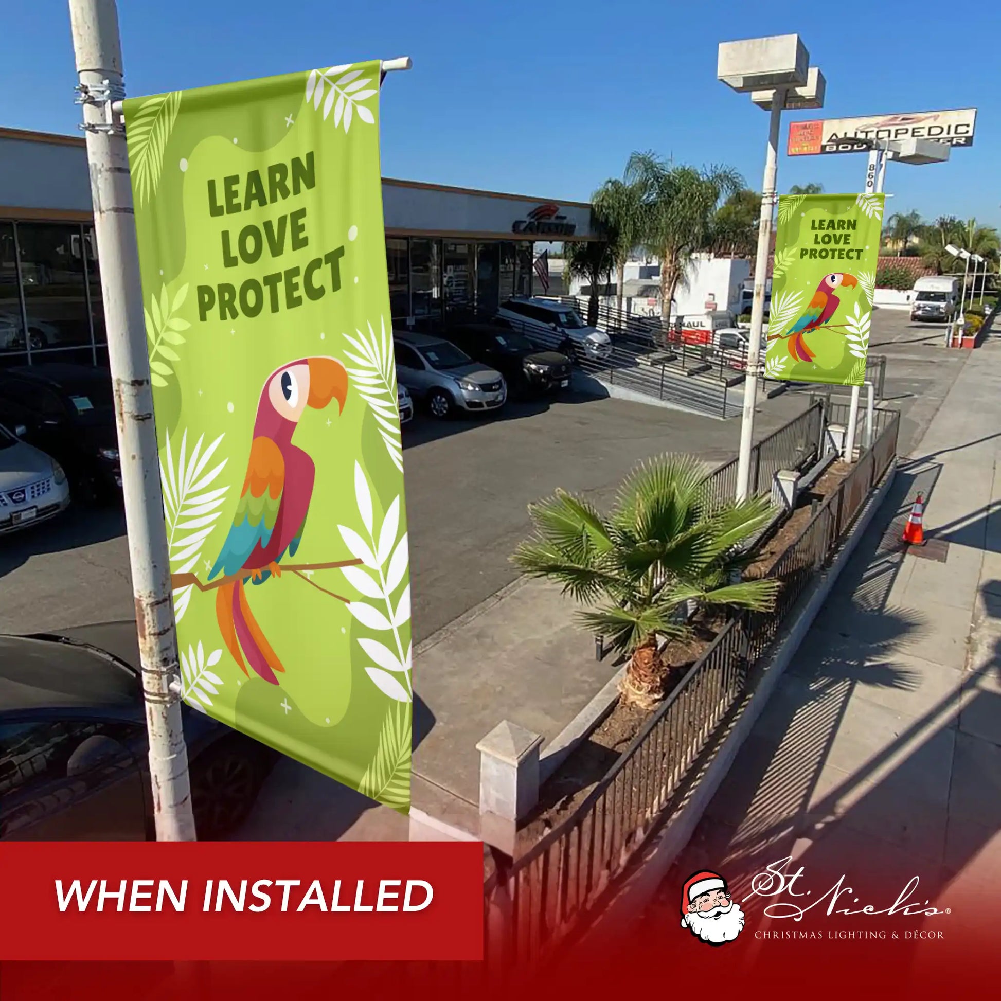 Learn Love Protect green outdoor street banner displayed along commercial walkway