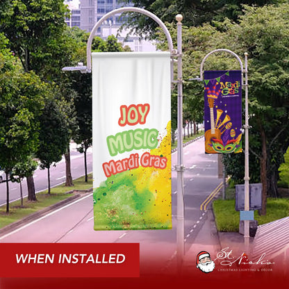 Joy Music Mardi Gras pole banner shown installed along city street with festive seasonal décor