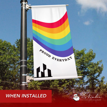 Proud Everyday pride pole banner with rainbow wave design shown installed on city street pole