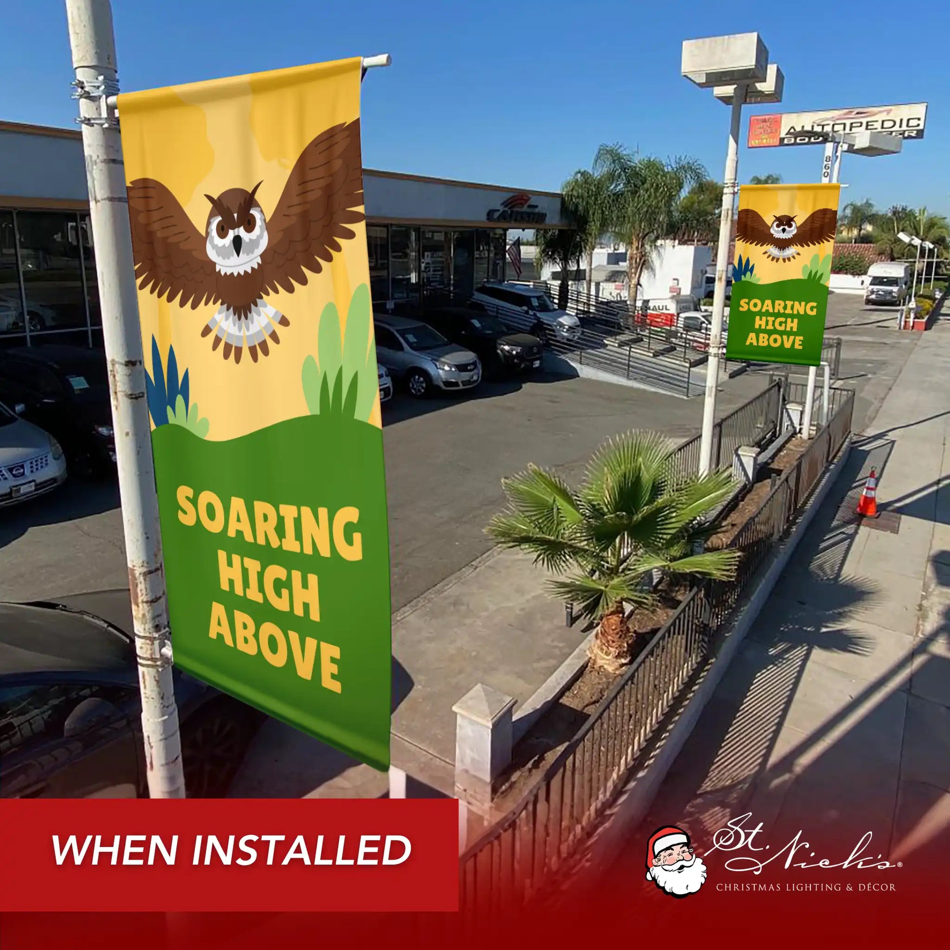 Soaring High Above owl street banner mounted on streetlight pole in commercial area