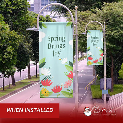 Spring Brings Joy spring pole banner installed along city street for seasonal decoration