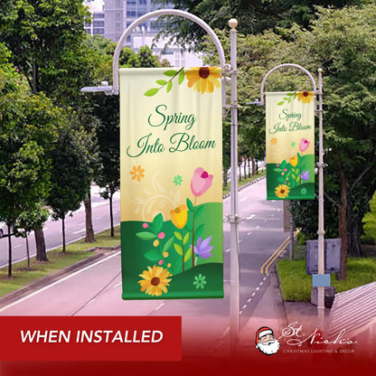 Spring Into Bloom spring pole banner displayed along city street for seasonal spring décor