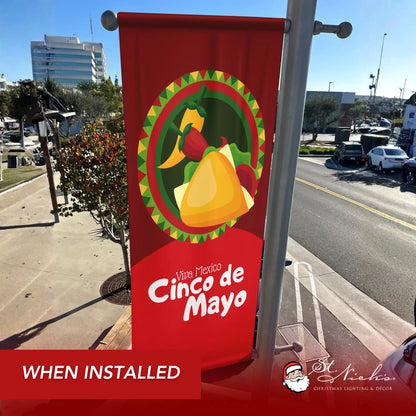 Viva Mexico Cinco de Mayo pole banner with taco design shown installed on downtown street pole