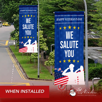 We Salute You blue Veterans Day street pole banner displayed along roadway