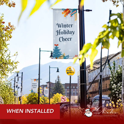 Winter Holiday Cheer winter pole banner installed along city street for seasonal decoration