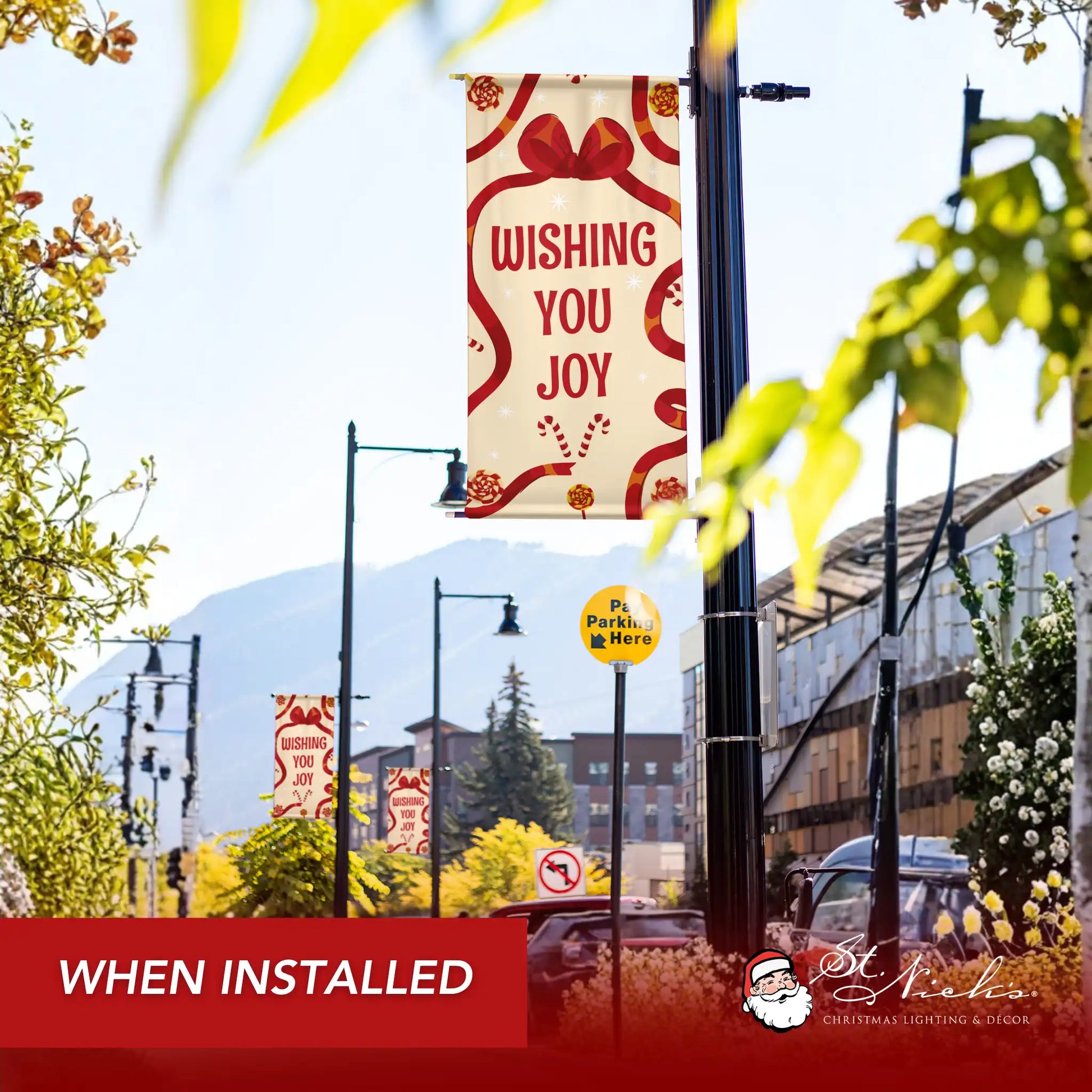 Wishing You Joy holiday pole banner installed along city street for festive seasonal décor
