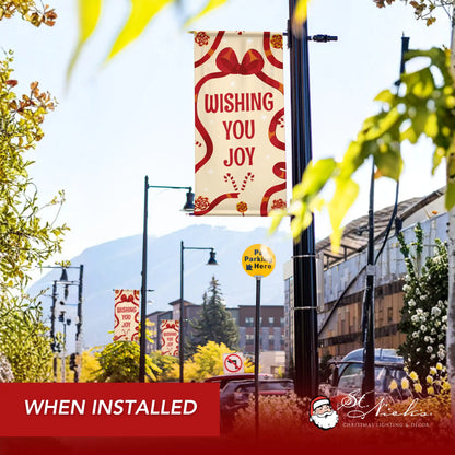 Wishing You Joy holiday pole banner installed along city street for festive seasonal décor