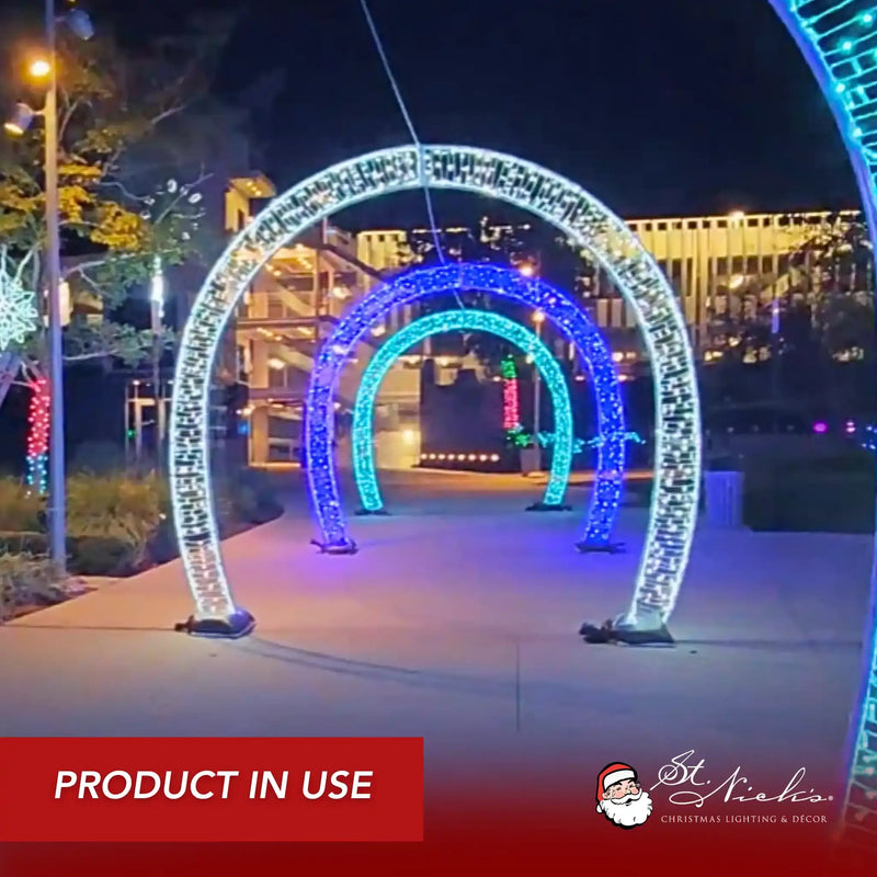 Lighted walkthrough arches forming illuminated holiday tunnel walkway in outdoor nighttime setting