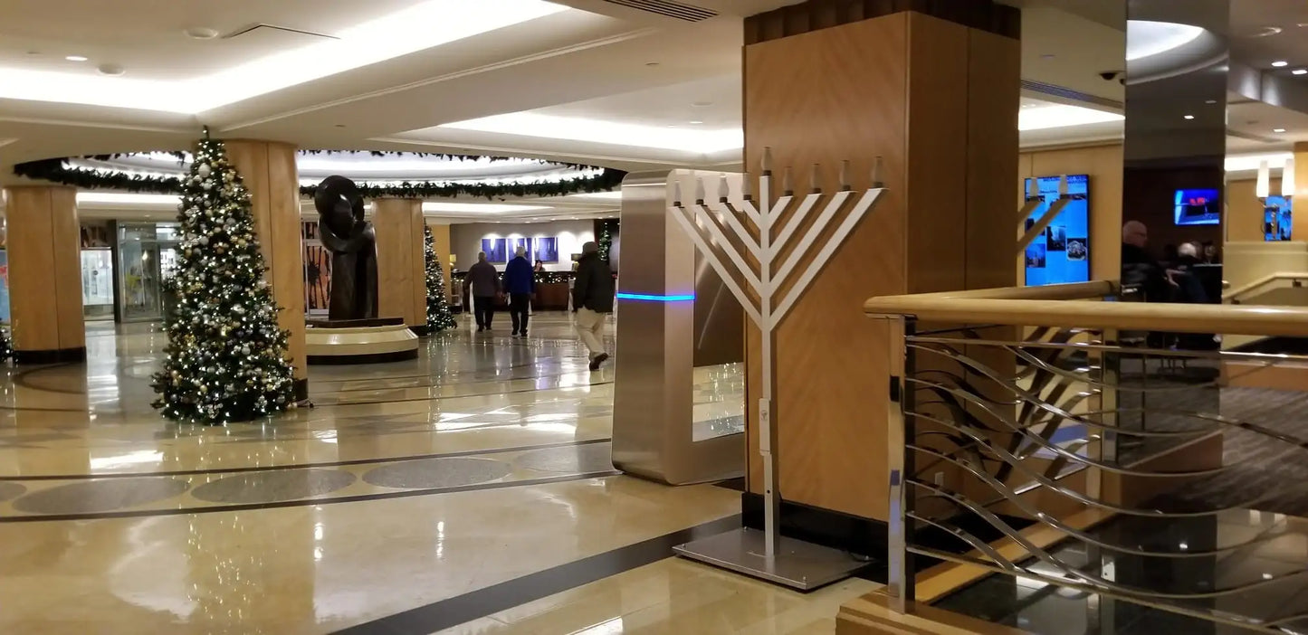Mall interior with a Christmas tree, garlands and a menorah