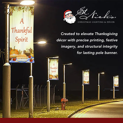A Thankful Spirit Thanksgiving pole banner illuminated at night for seasonal street decoration