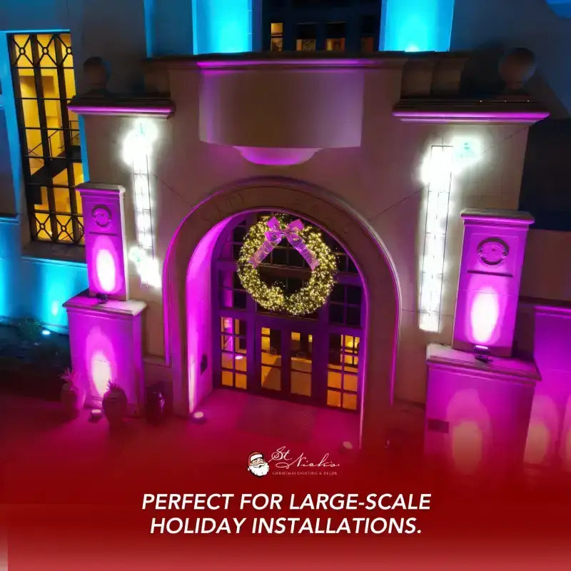 Decorative archway with wreath and purple lighting, suitable for large-scale holiday installations.