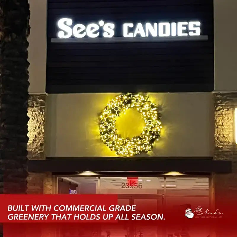 storefront with a decorative wreath and christmas lights
